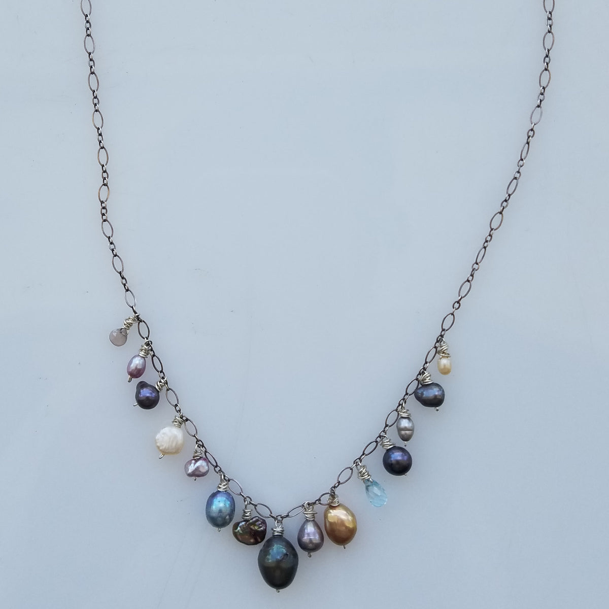 Swinging Pearls necklace in white, handcrafted by Antiqua Jewelry
