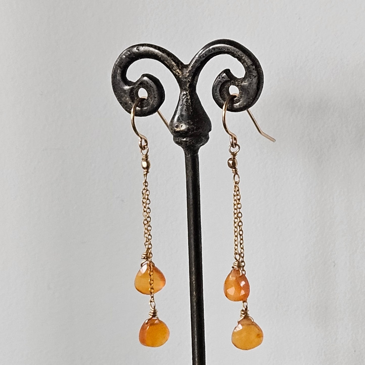 Dancing Carnelian earrings in orange and gold, handcrafted by Antiqua Jewelry