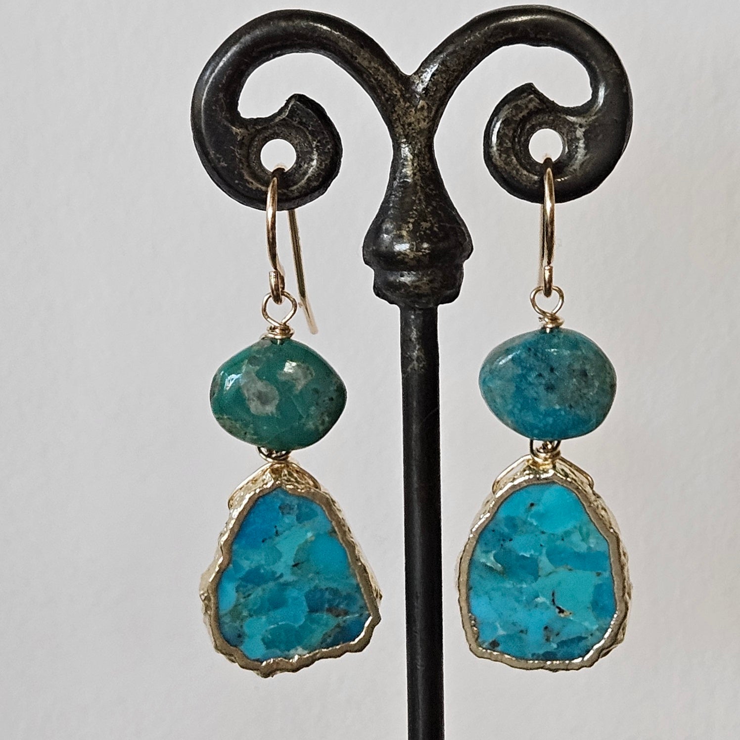 Flat oval Turquoise earrings in blue and gold, handcrafted by Antiqua Jewelry