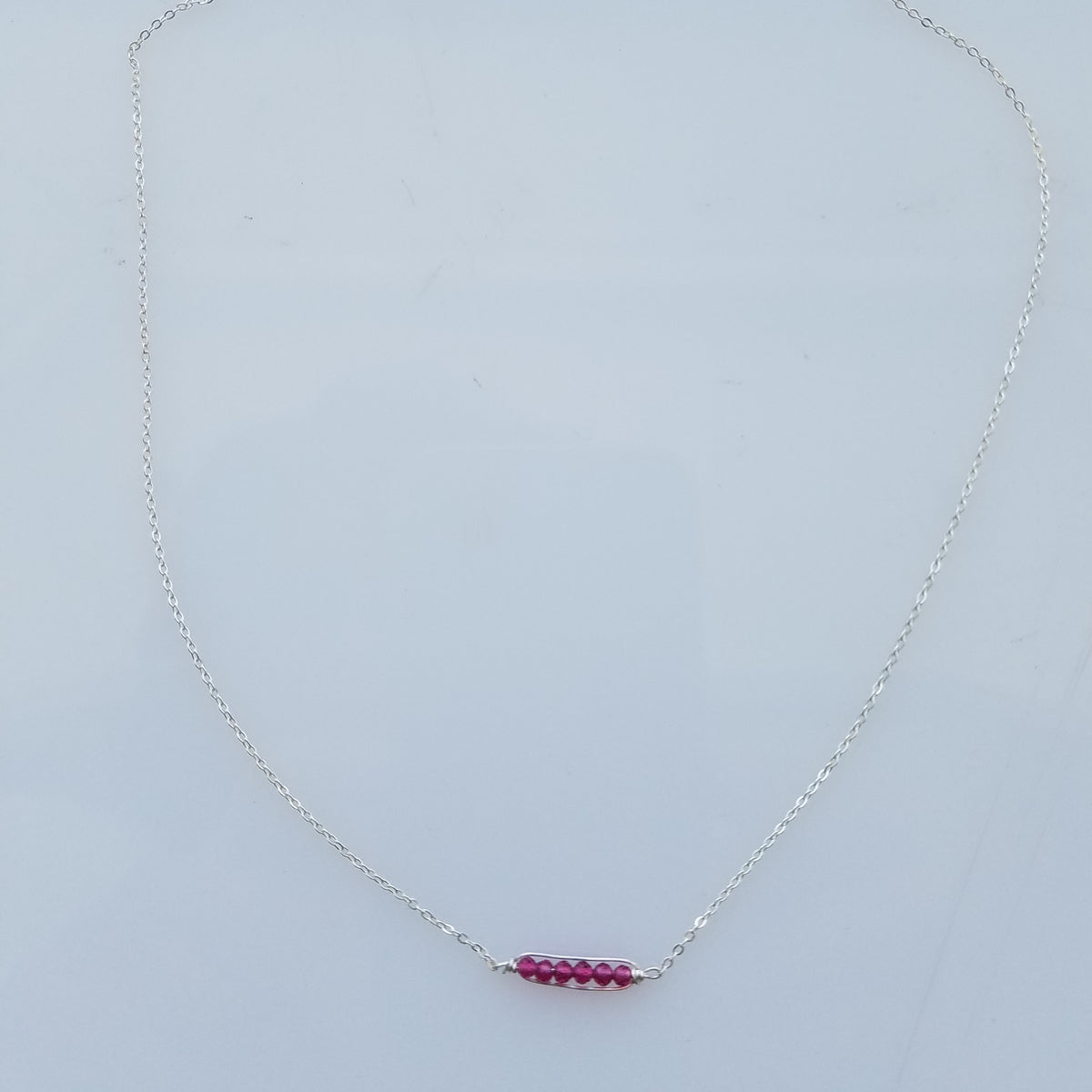 Dainty garnet necklace in red, handcrafted by Antiqua Jewelry