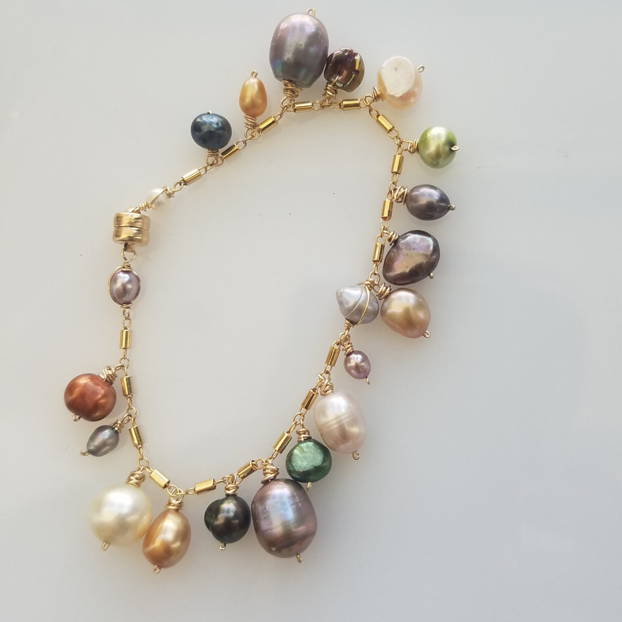Pearl charms bracelet in white, handcrafted by Antiqua Jewelry