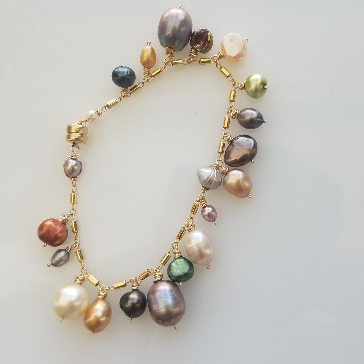 Pearl charms bracelet in white, handcrafted by Antiqua Jewelry