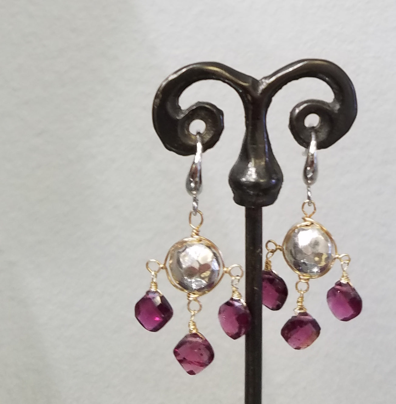 Hammered silver and garnet earrings, handcrafted by Antiqua Jewelry