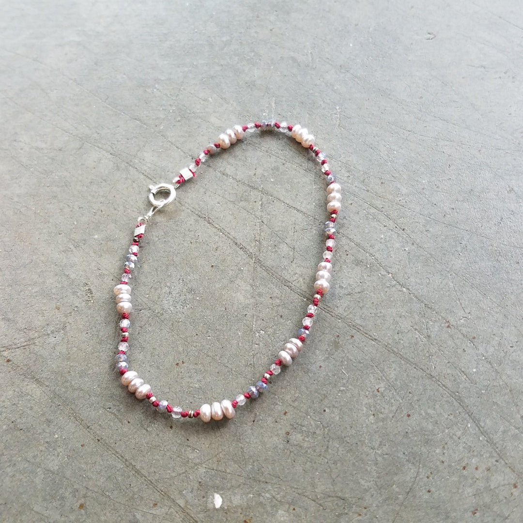 Pearls on red string bracelet, handcrafted by Antiqua Jewelry